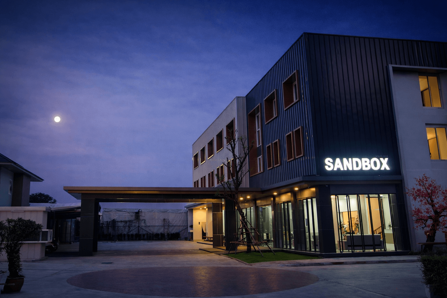 Sandbox Hotel exterior view at dusk with a warm evening glow